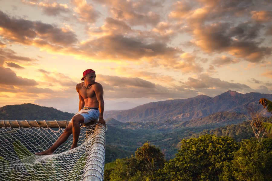 Hombre observando el atardecer en Minca, en un mirador. De fondo se observa la Sierra Nevada de Santa Marta. 